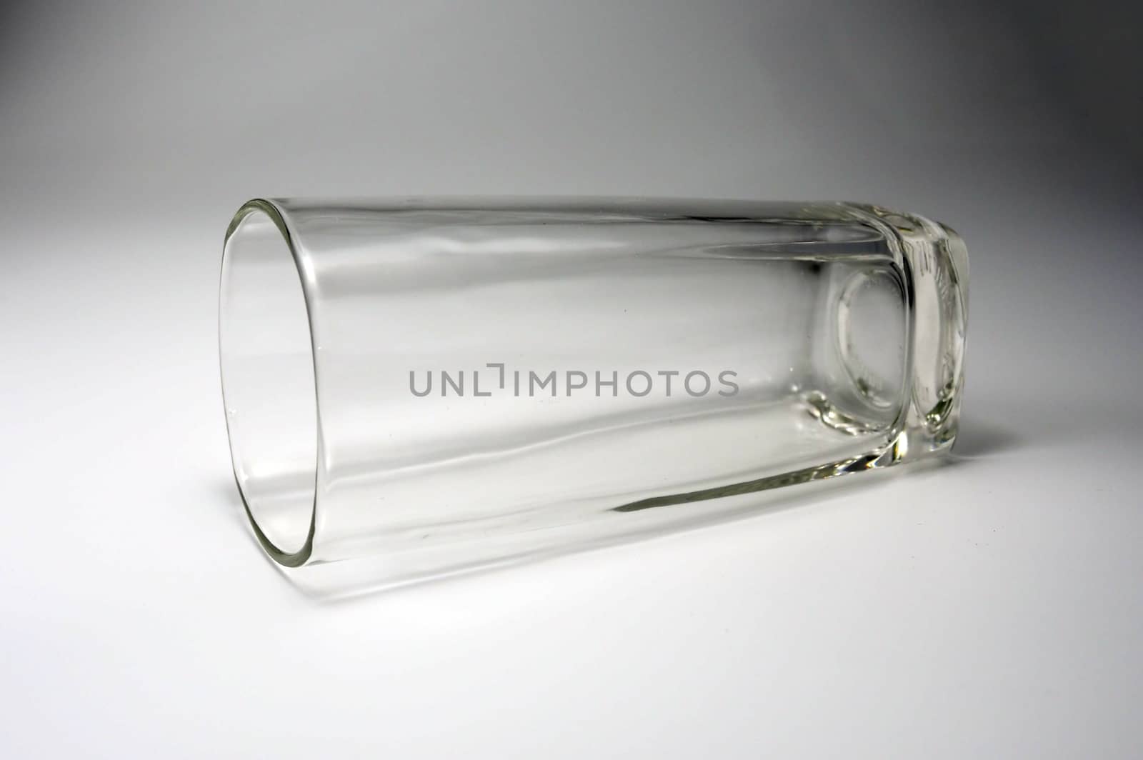 Empty glass Lying on a white background. by Unimages2527