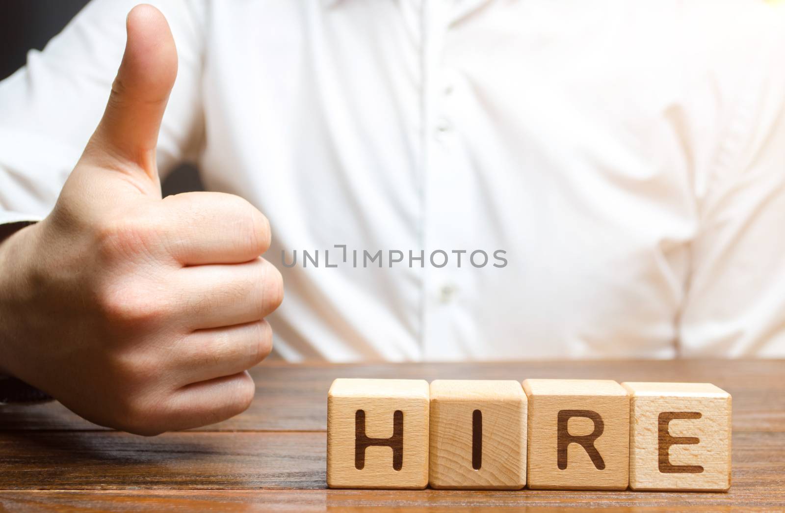 Businessman shows thumb up and hiring inscription. Consent to hire an employee, good recommendations. Recruitment concept. Search for employees and professionals on favorable terms.