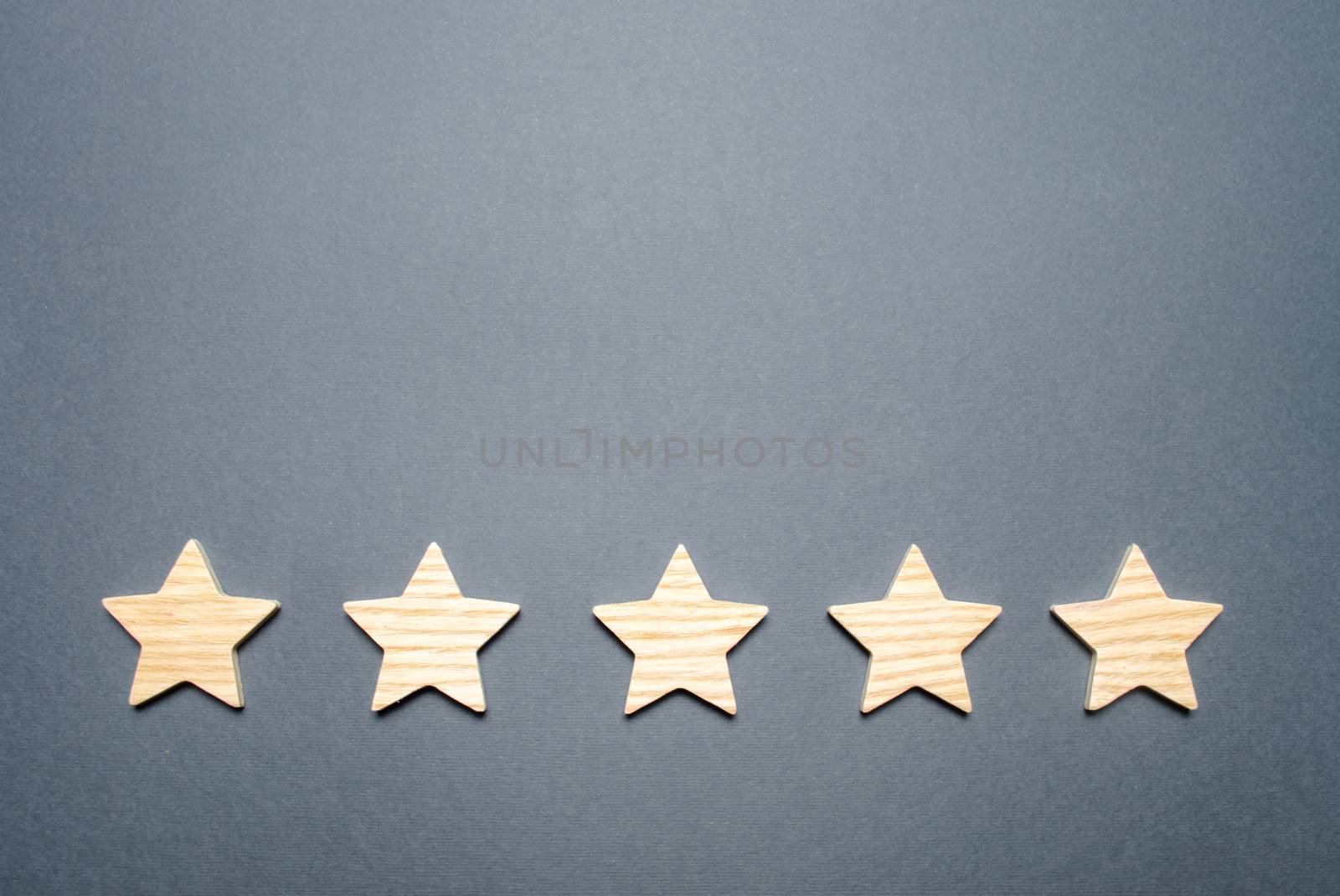 Five stars on a gray background. Rating and status of the restaurant or hotel. Prestige and a good title. High quality and reliability, universal acceptance. Pretentiousness, confidence and good name.