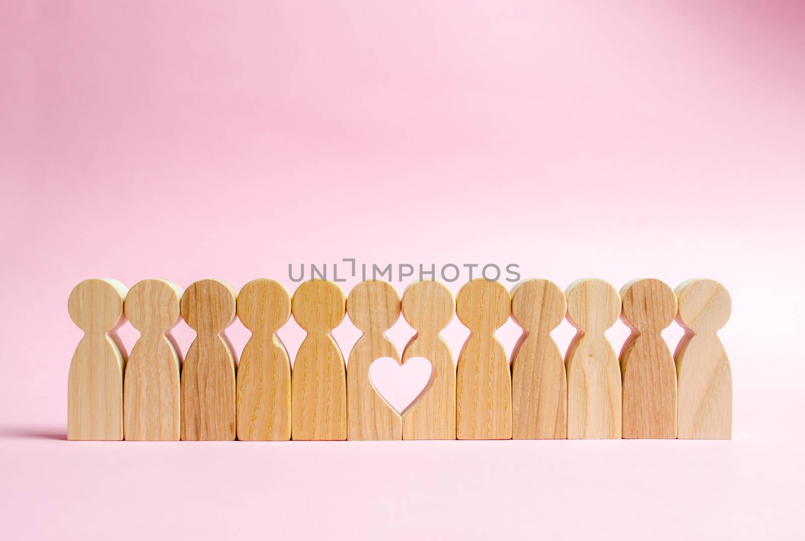 Two figures of people in a row form a void in the shape of a heart. Concept of love and search for the second half. Find a soul mate and start a family. Love and romance, real secret feelings