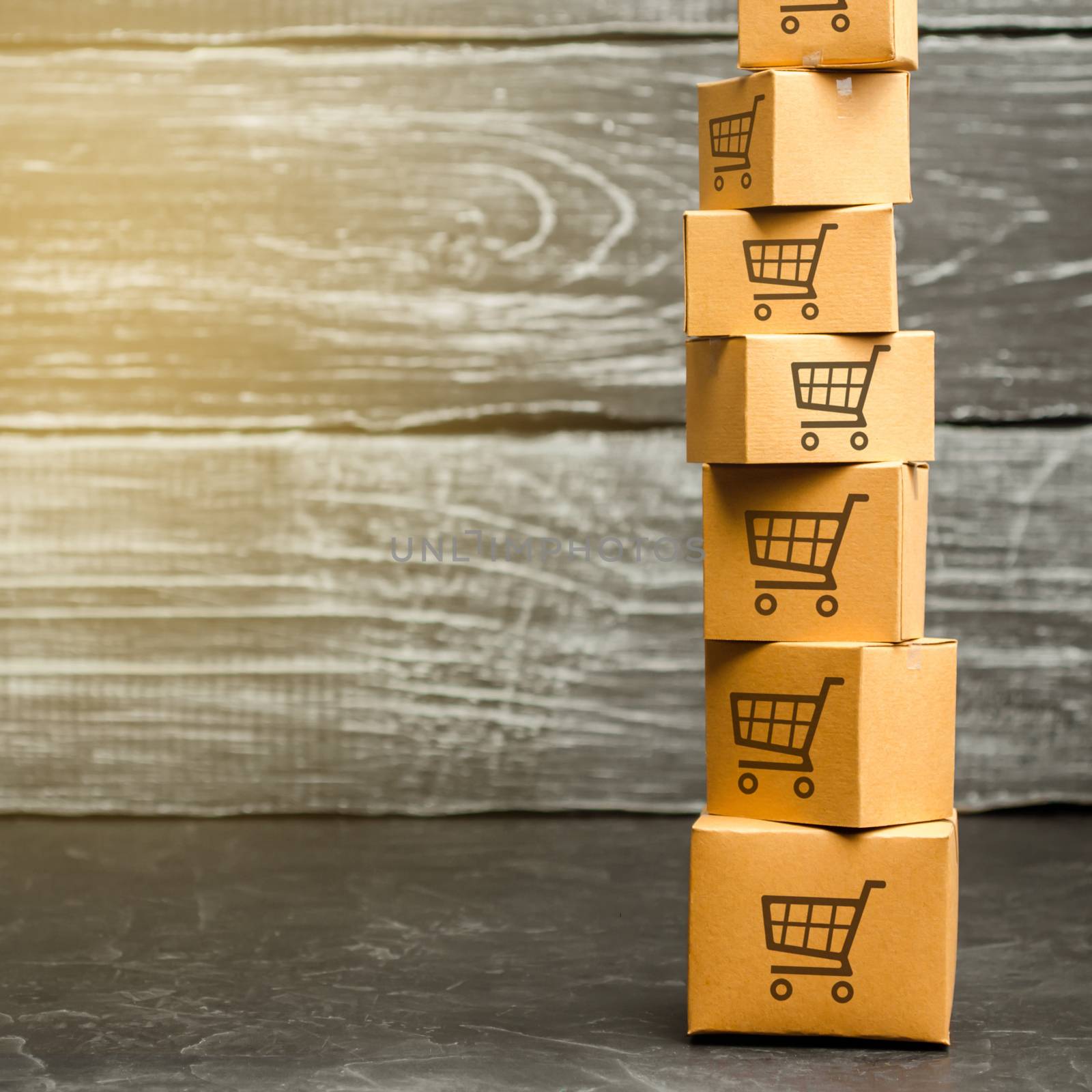 Tower of cardboard boxes with pattern of shopping carts. Purchasing power, delivery order. E-commerce, logistics, distribution. commerce, online shopping. Sales of goods and services. Copy space