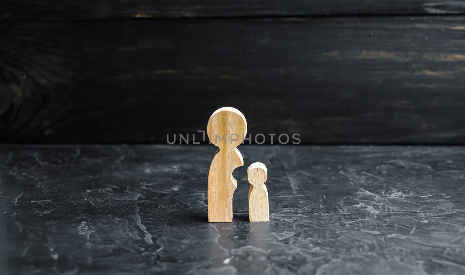 Wooden figures of mother and child. The baby is separated from the mothers body. The concept of maturation and self-reliance. Under the wing of the mother. Child education.