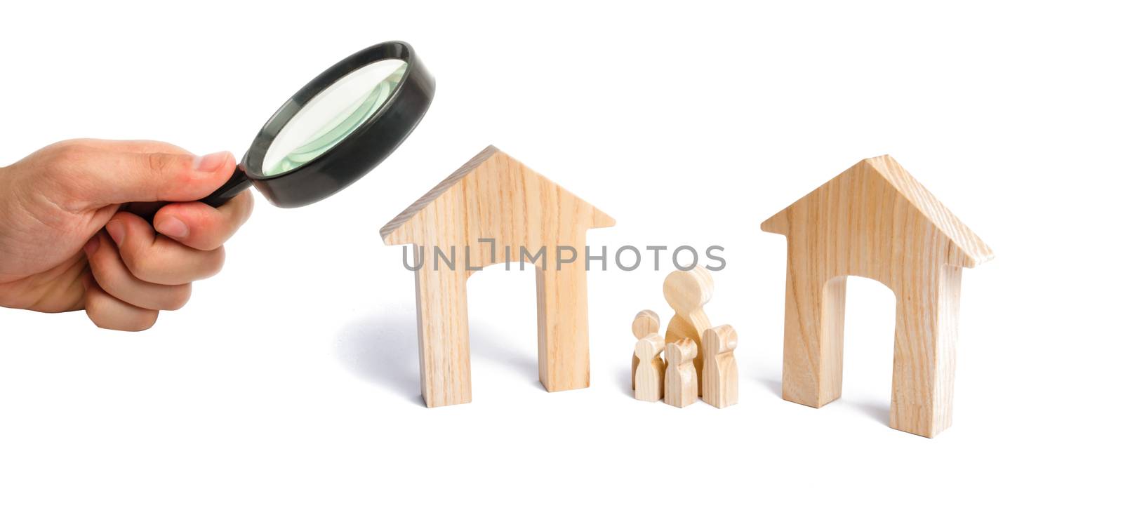 Magnifying glass is looking at the family with children stand between two houses. the designation of the future family. make a decision, they make a choice.