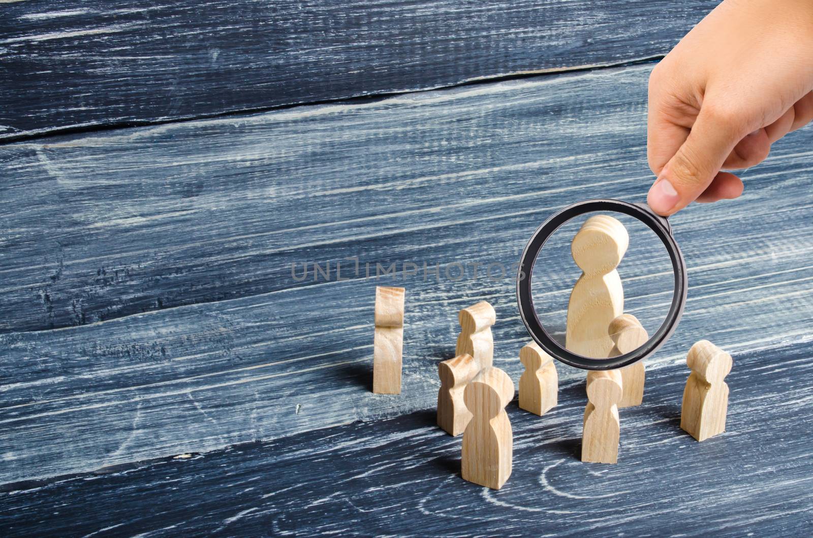 Magnifying glass is looking at the children gathered around the teacher. Lesson from the teacher, school lesson. The system of education, instruction. Classroom. Teacher and pupils.
