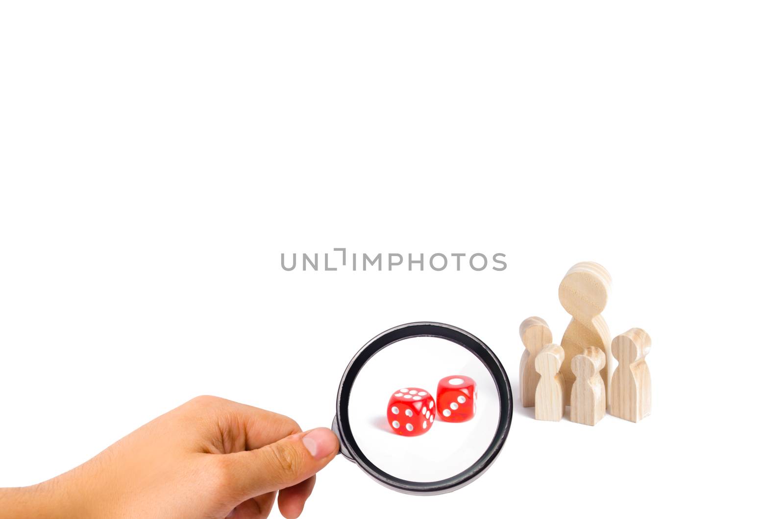The concept of gambling, the dependence on gambling. Destruction of the family. Magnifying glass is looking at the People are standing near dice. The family stands near the dice cubes.