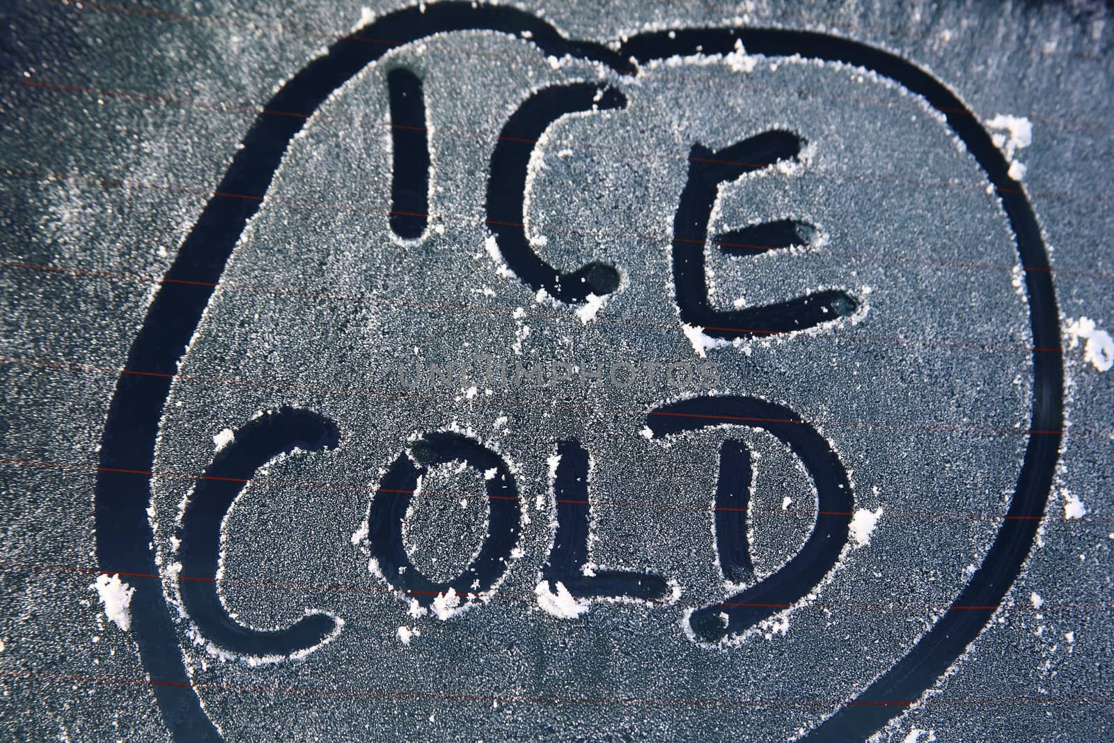 Frozen car window with a frost ice cold message text sign in the winter stock photo