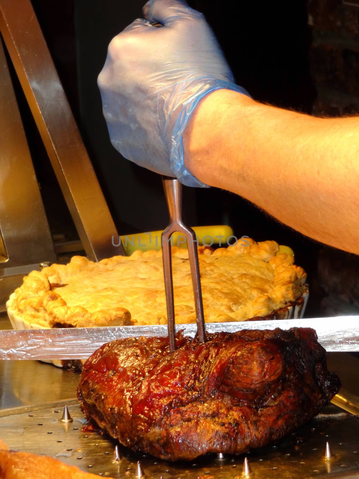 Chef carving roast beef and other meats at a buffet carvery stock photo                          