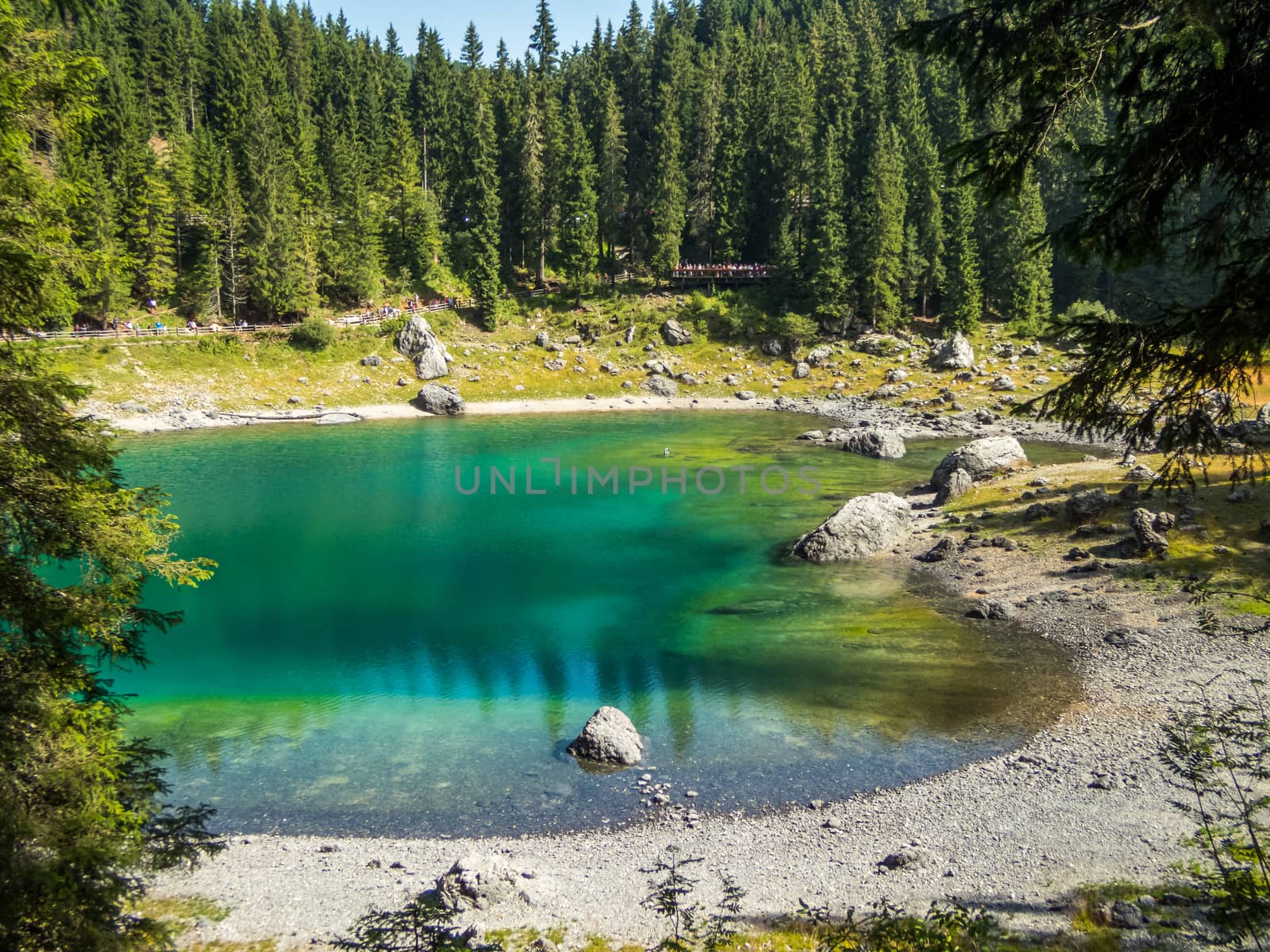 The Karersee below the Karerpass at the foot of the Latemar massif in South Tyrol, Italy