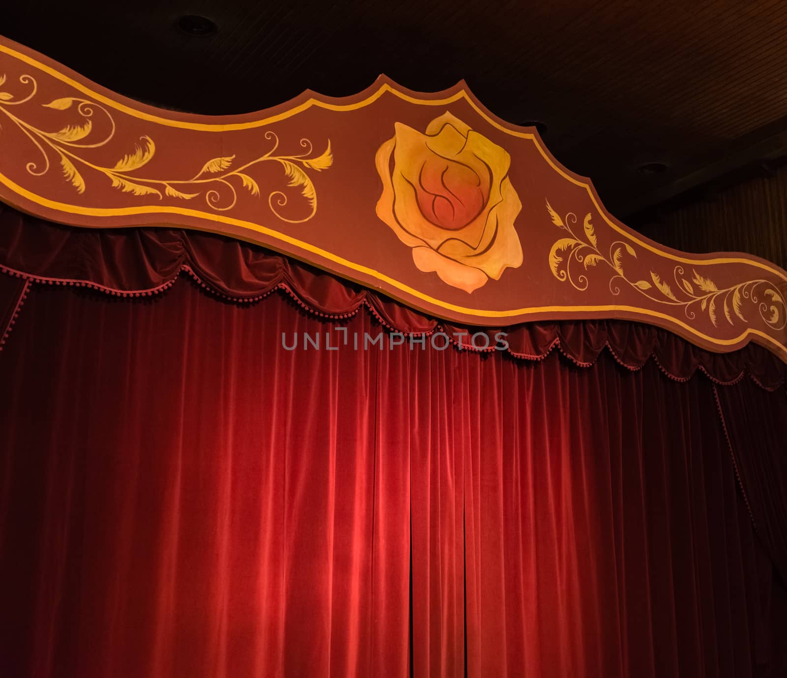 Stage with red curtains and a yellow rose. stage for shows