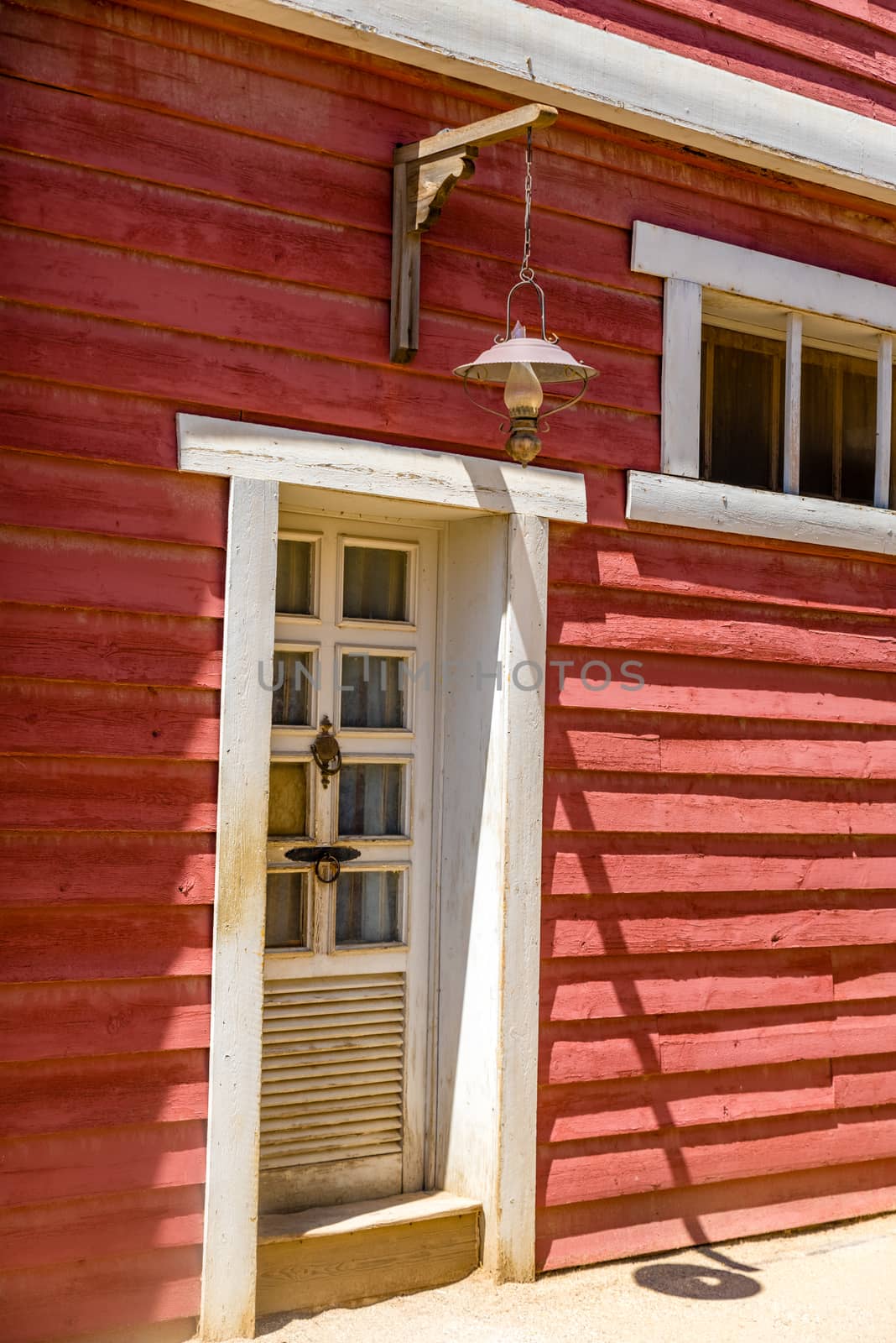 white vintage wooden door with red wall