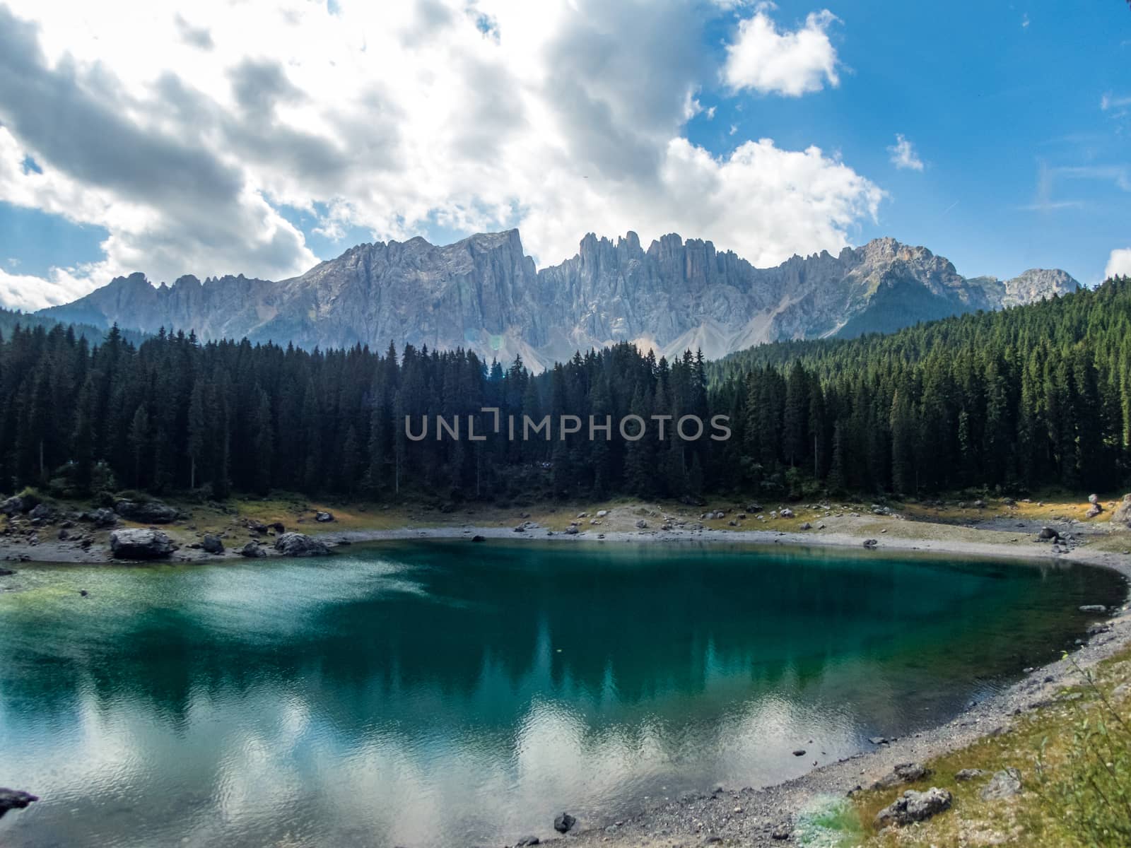 The Karersee below the Karerpass at the foot of the Latemar massif in South Tyrol, Italy