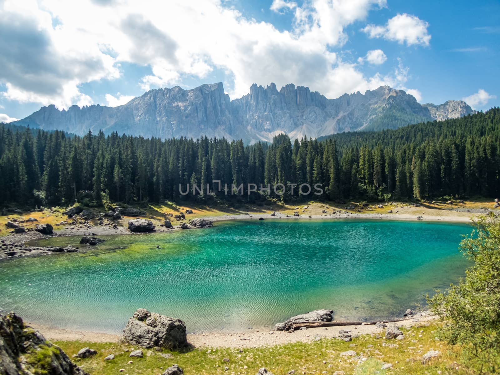 The Karersee below the Karerpass at the foot of the Latemar massif in South Tyrol, Italy
