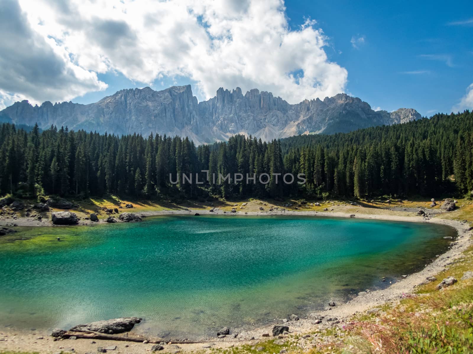 The Karersee below the Karerpass at the foot of the Latemar massif in South Tyrol, Italy