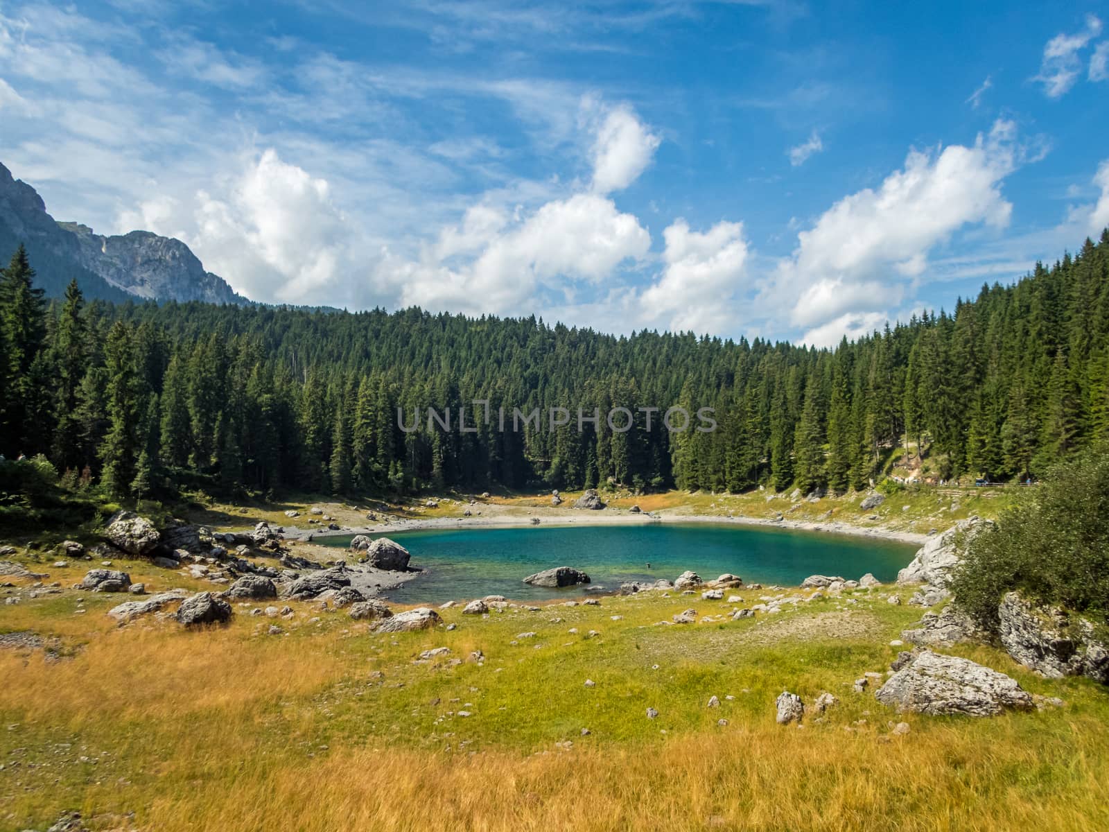 The Karersee below the Karerpass at the foot of the Latemar massif in South Tyrol, Italy