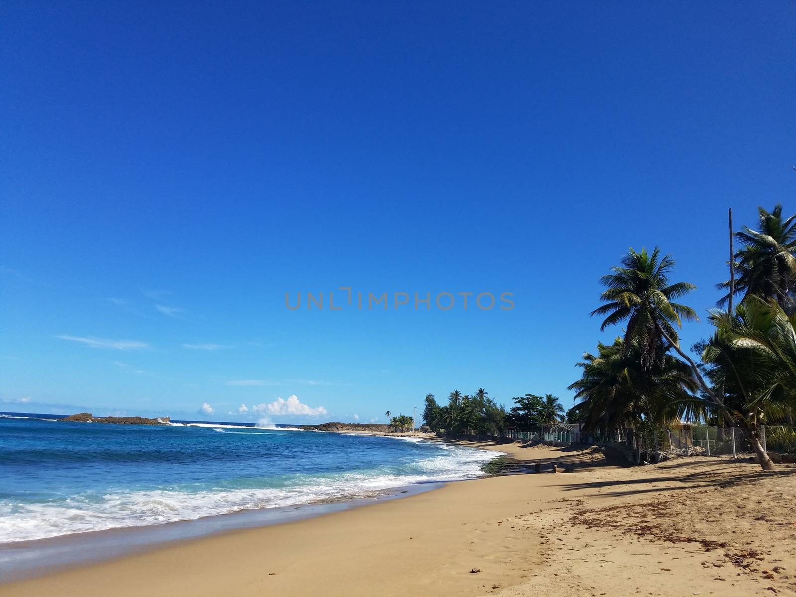 sand and ocean water on beach in Isabela, Puerto Rico by stockphotofan1