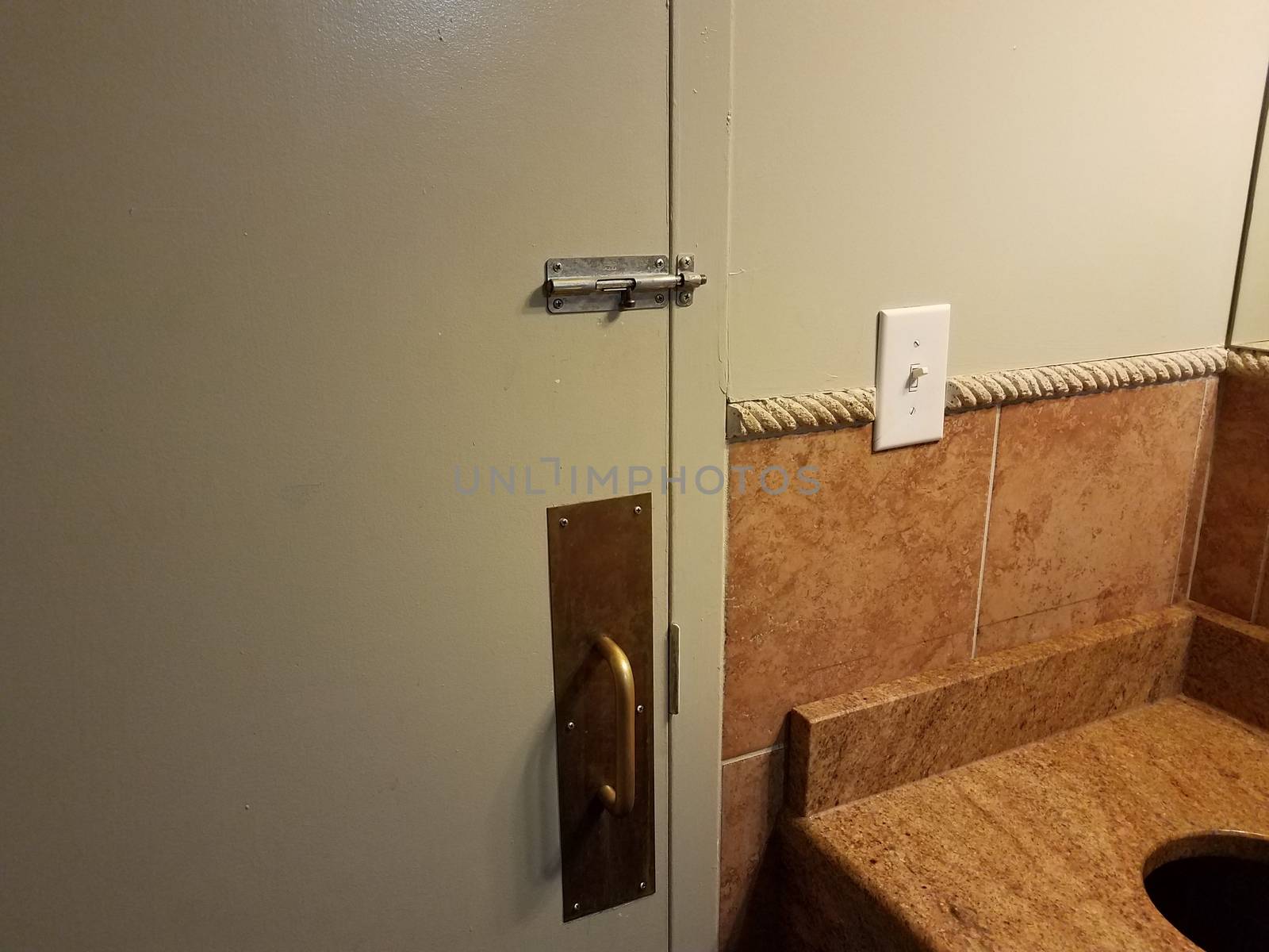 locked bathroom or restroom door with metal handle and counter