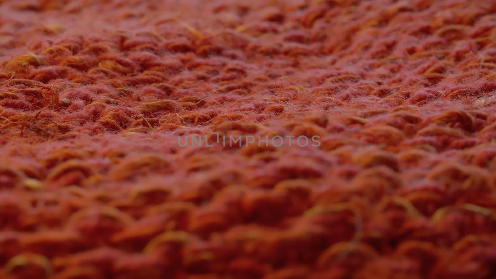 Macro shot of red knitted hemp fabric. Textile background, texture