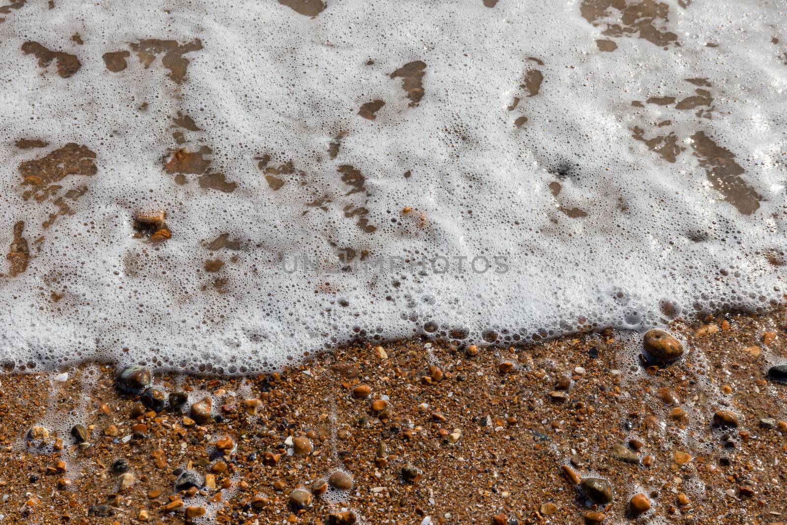 Waves lapping the pebbles on Brighton beach, England, United Kingdom