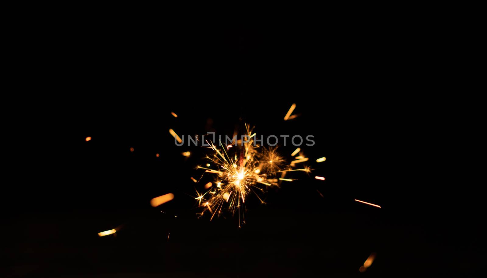 Sparkler background. Christmas and new year sparkler holiday background. bengal light on the black background
