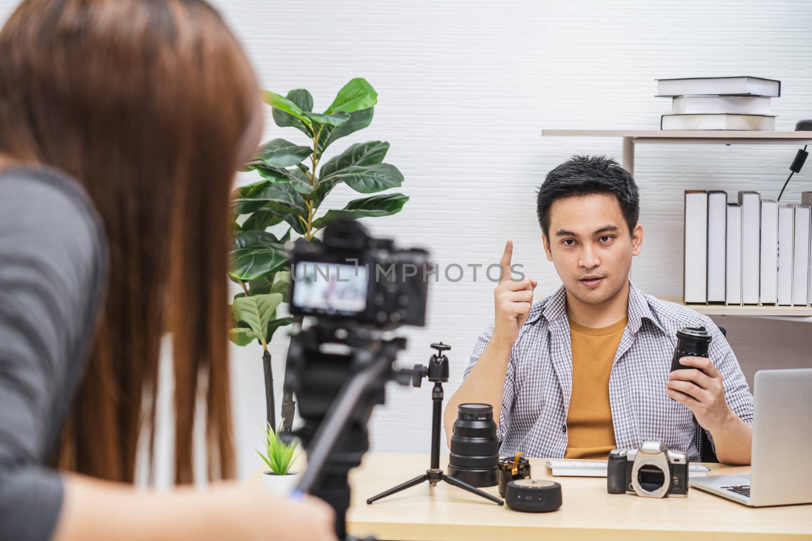Camera taking video and live with laptop of Asian Vlogger man satisfied the camera lens each media, sharing knowledge to audience via camera by social media channel,vlog and Influencer concept
