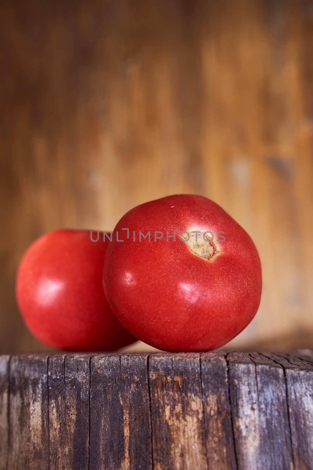 Ripe red tomatoes lie on a wooden frame. High quality photo