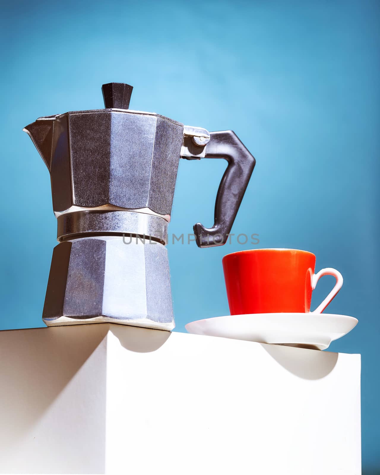 Geyser coffee maker and red cup for coffee shop stand on a white cube. High quality photo