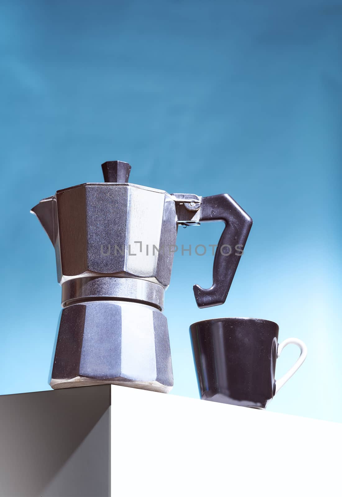 Geyser coffee maker and black cup for coffee shop stand on a white cube. High quality photo
