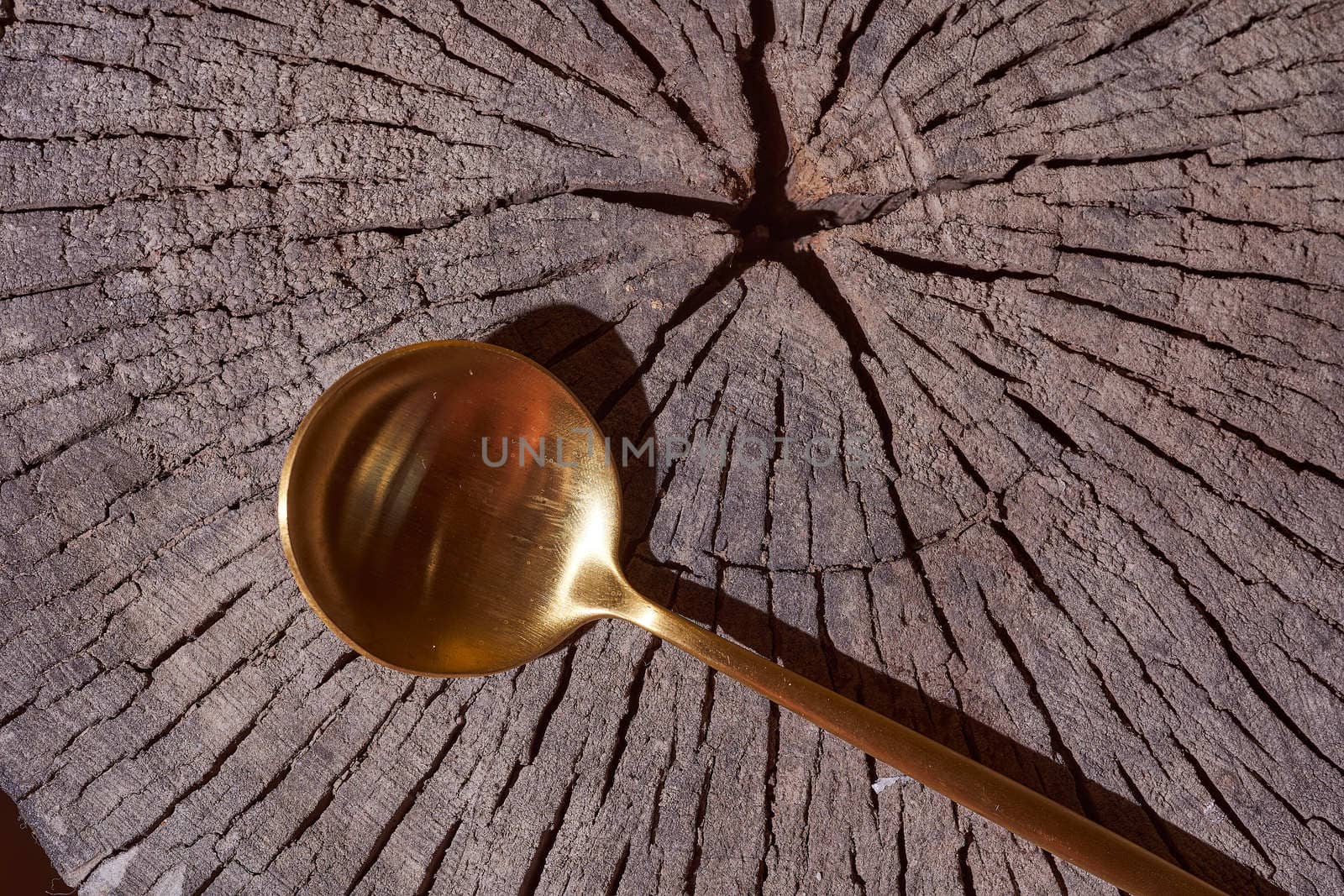 Golden Spoon lays on the wooden frame. he. High quality photo