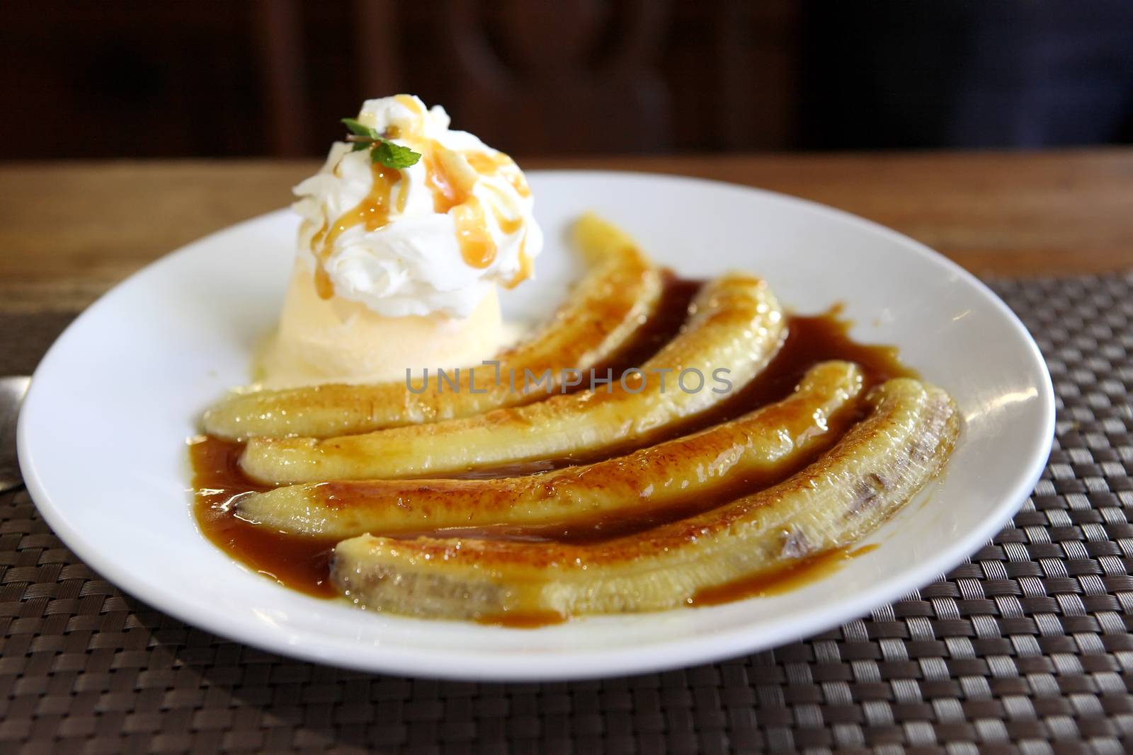 Dessert ice cream with sweet banana on wood background