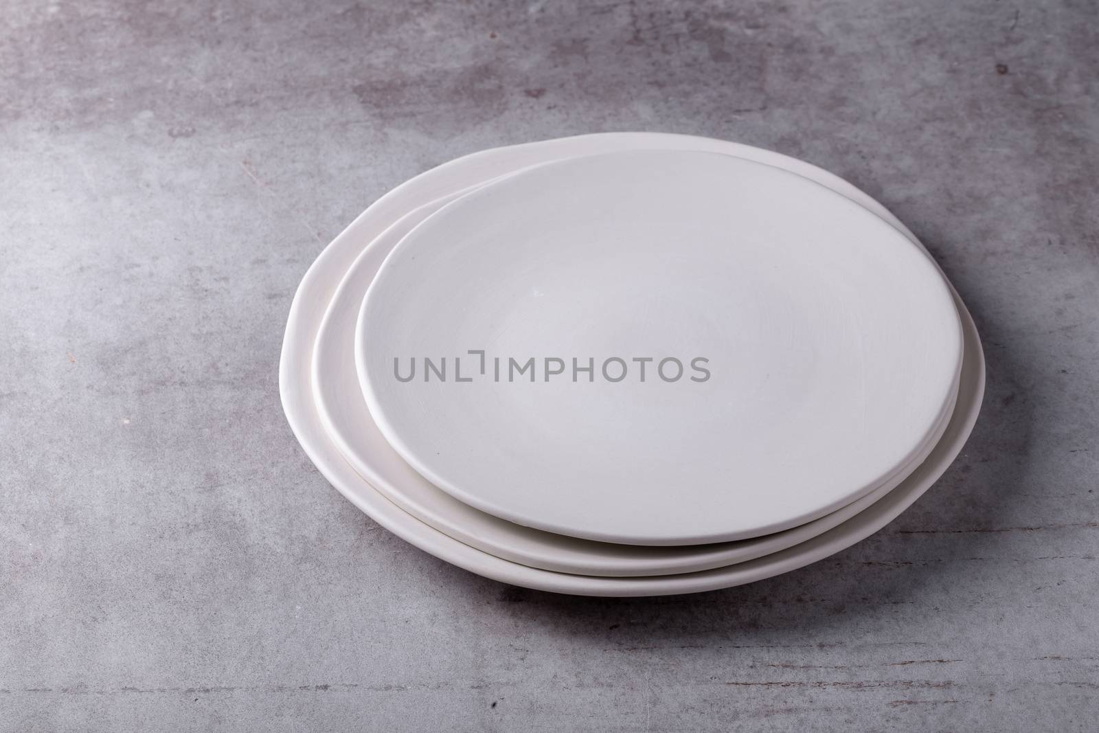 Empty blank white ceramic dish on Cement Board by kaiskynet