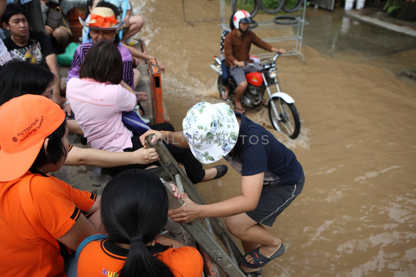 CHIANGMAI , THAILAND - SEPTEMBER 30 : People climb to truck on September 30, 2011 in Nonghoi , Muang , Chiangmai , Thailand.