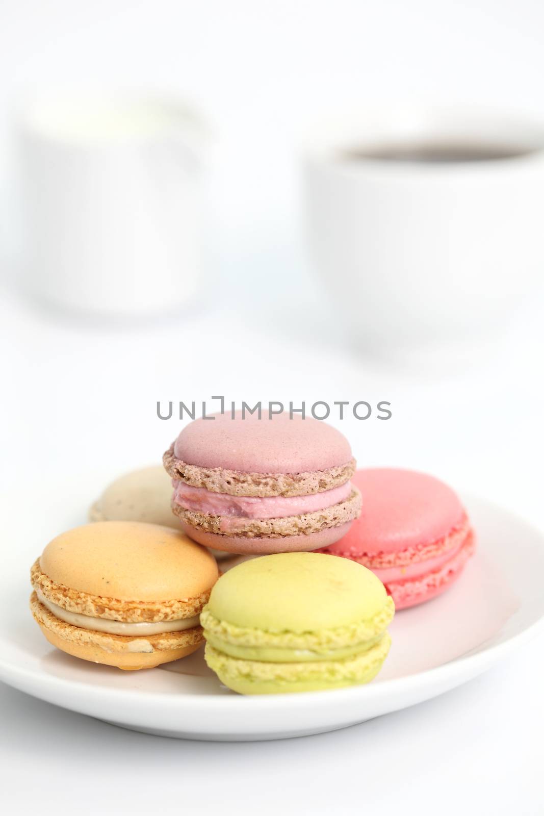 Colorful Macaron with coffee in close up isolated on white background