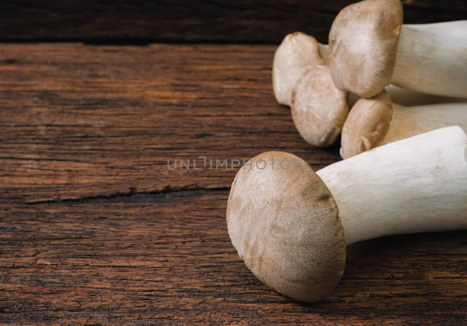 Mushroom on an old wooden table by sompongtom