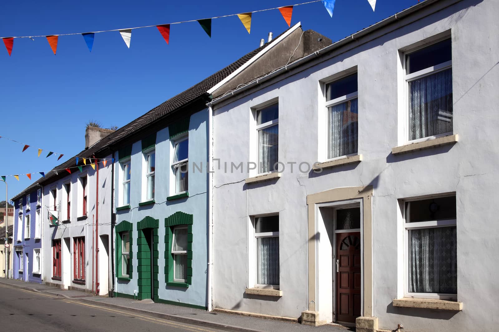 Old fashioned colourful terraced town houses in Kidwelly Carmarthenshire Wales UK stock photo