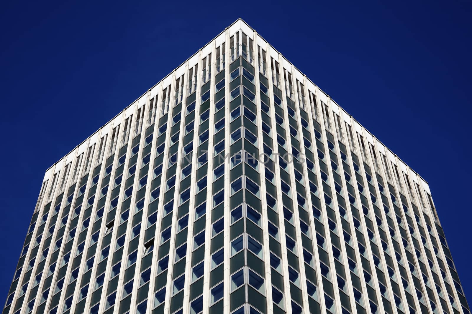 Modern tower block office skyscraper building of  futuristic architecture with a clear blue sky in a downtown financial business district in England UK stock photo