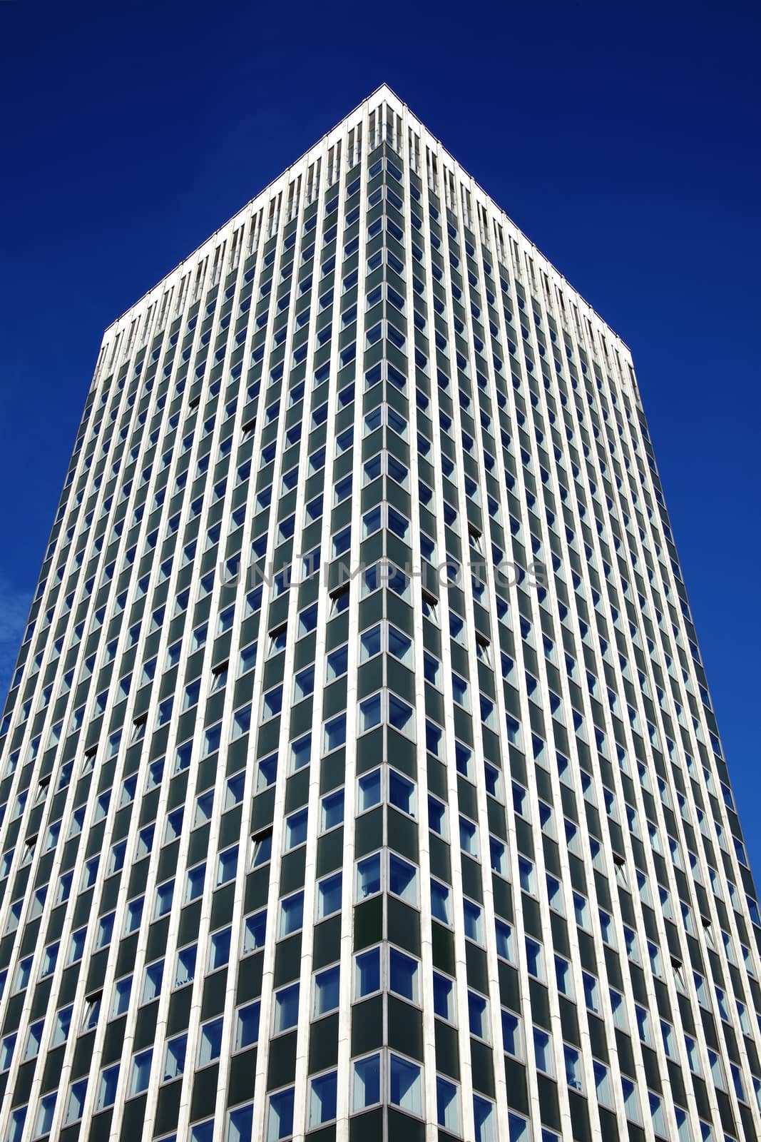 Modern tower block office skyscraper building of  futuristic architecture with a clear blue sky in a downtown financial business district in England UK stock photo