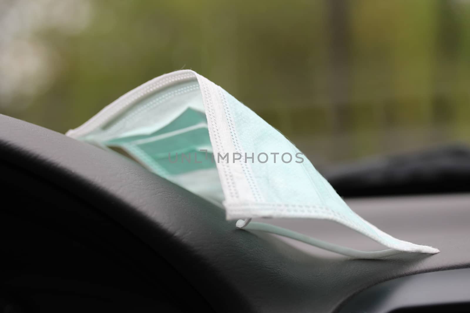 closeup of a medical mask on the dashboard in the car