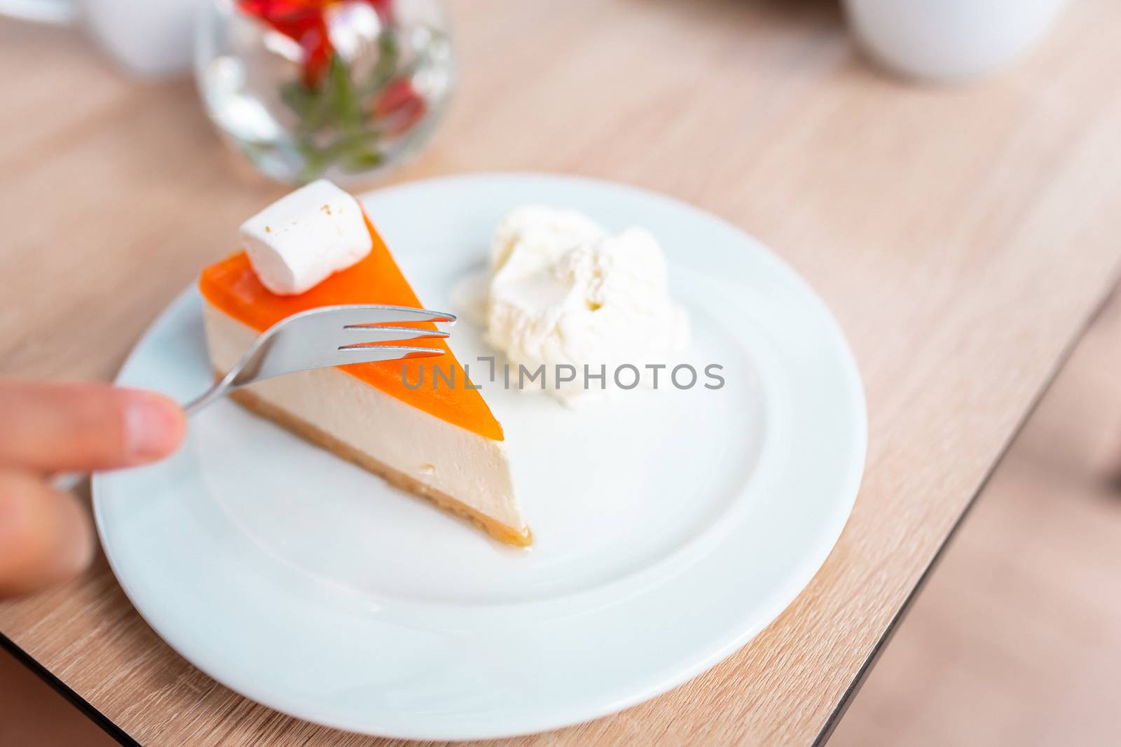 A piece of delicious original cheesecake served with ice cream