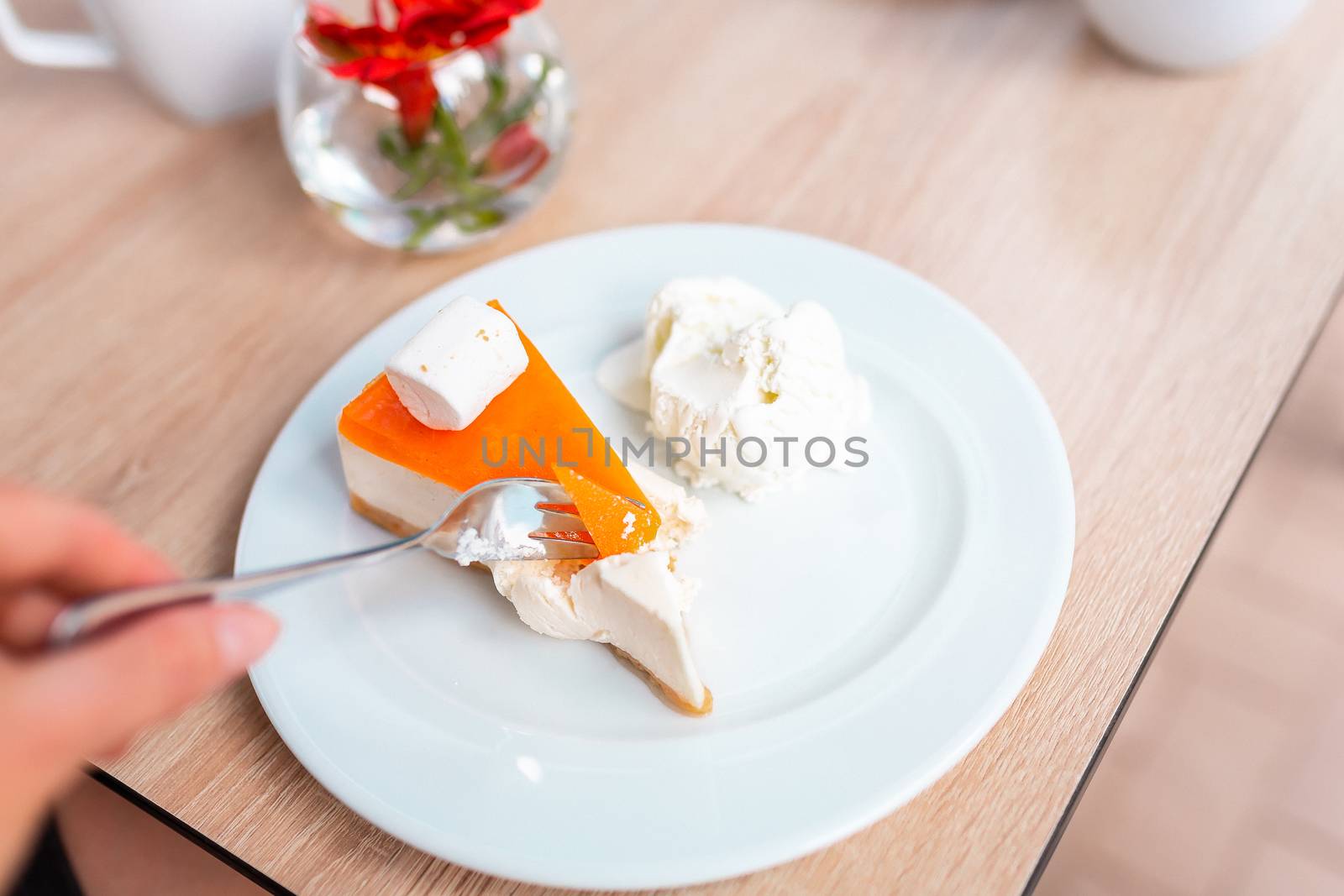 A piece of delicious original cheesecake served with ice cream