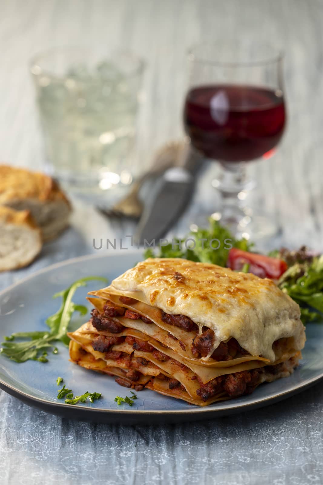 portion of lasagna with wine