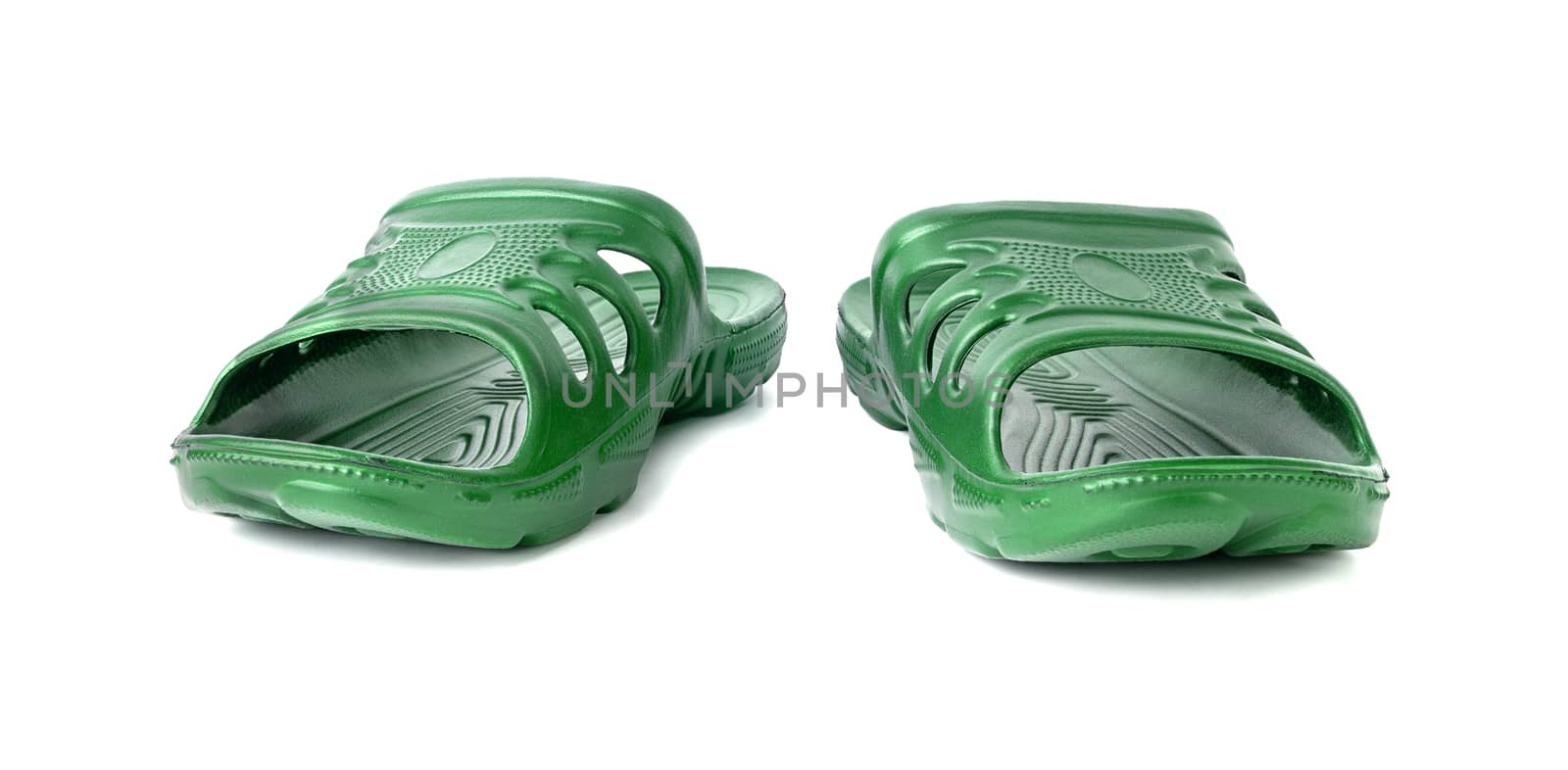pair of cheap durable green rubber slippers isolated on white background. by z1b