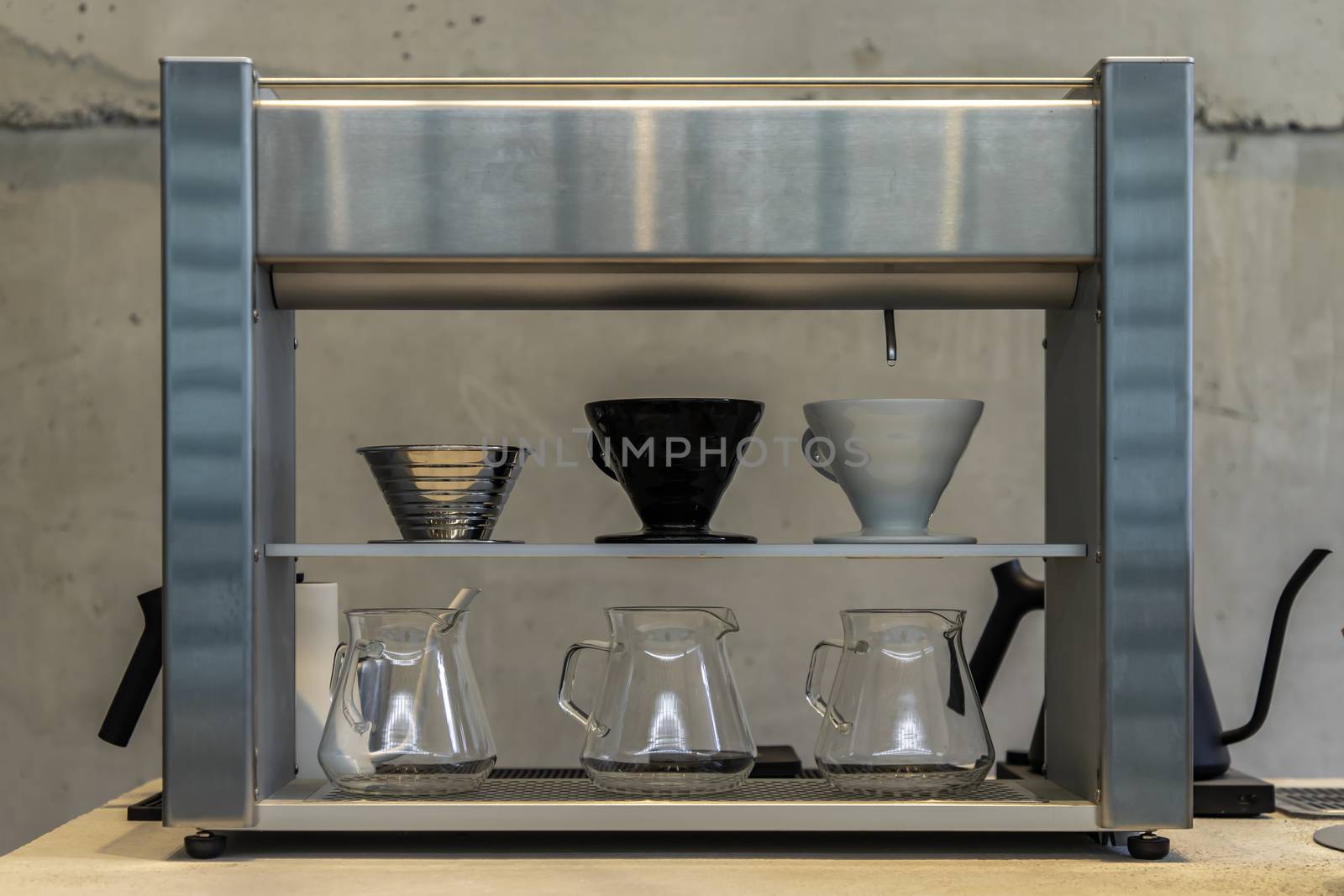 Automatic accumulating drip coffee machine pour-over coffee better on white table. Selective focus.