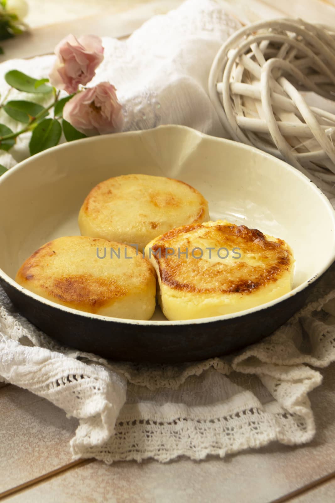 Delicious cottage cheese pancakes on rustic pan, vertical image