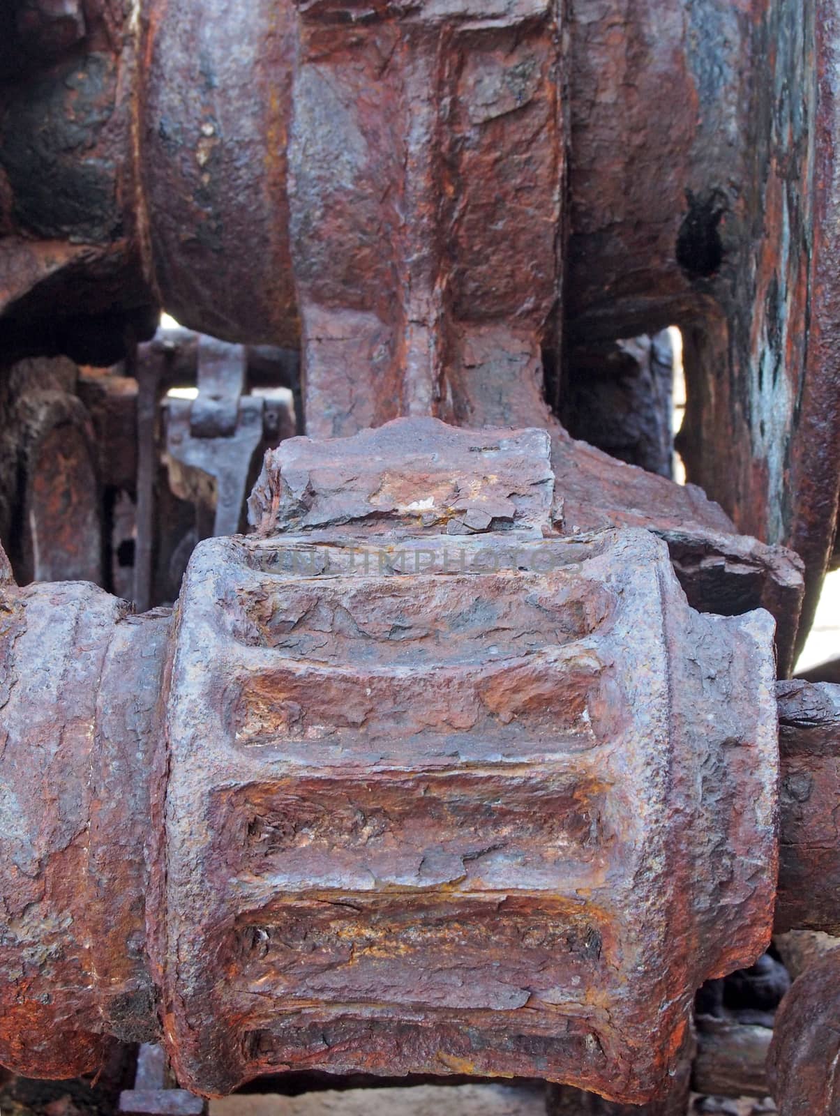 a close up of rusted cogs and gears on an old broken industrial machine