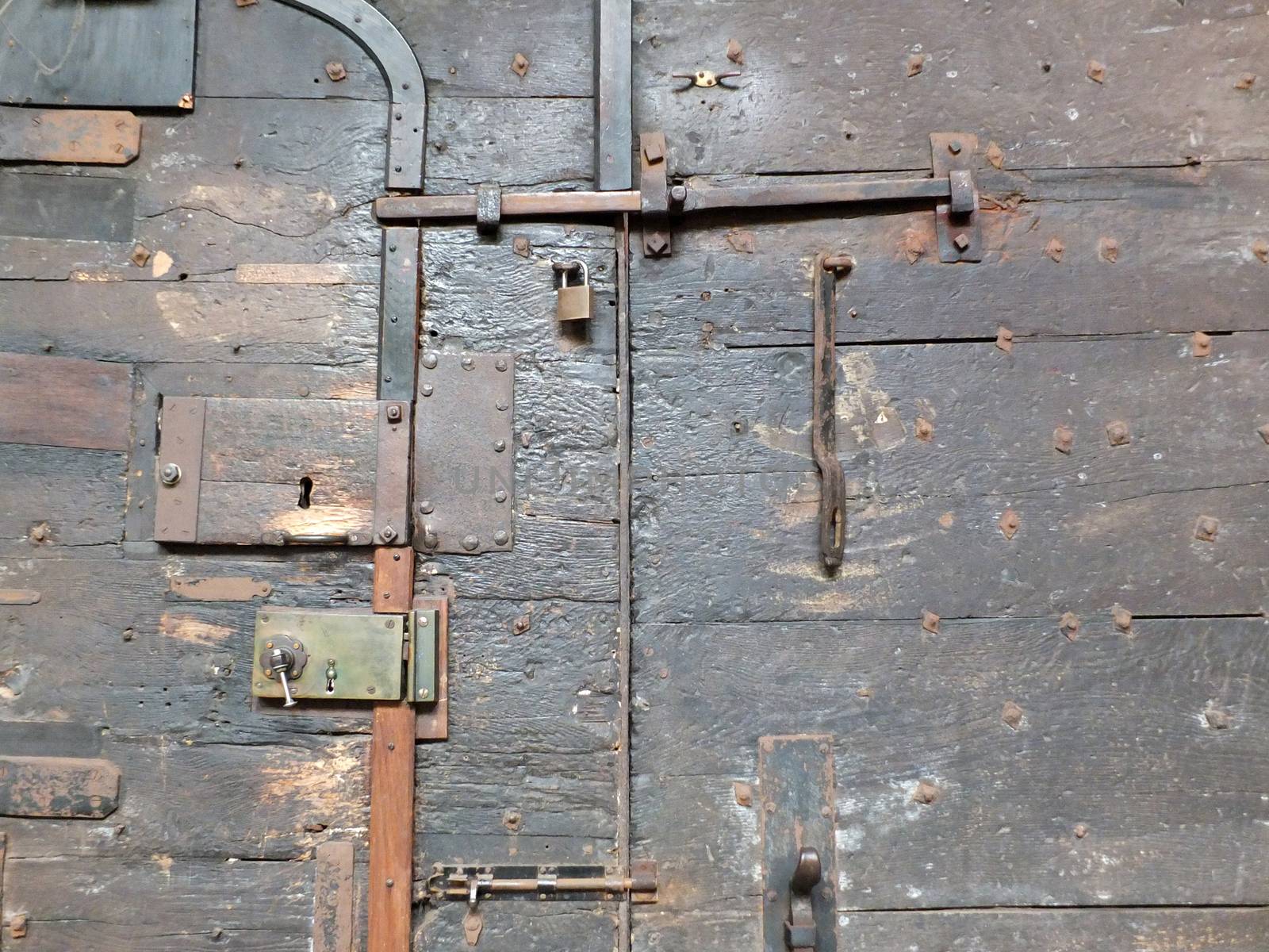 ancient black wooden medieval door with iron locks and bolts on chester cathedral