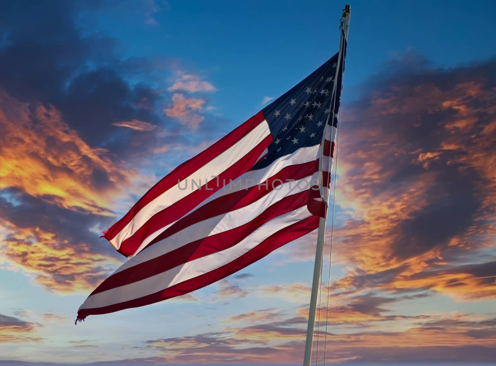 The American flag flying against a clear blue sky