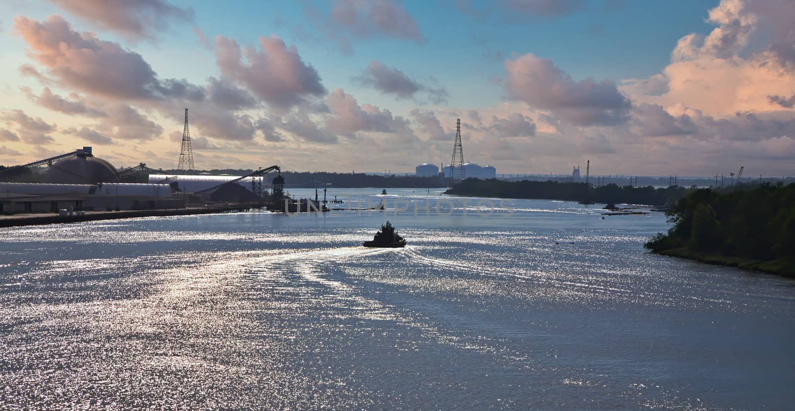 A tugboat heading down the Savannah River in the late afternoon lightg