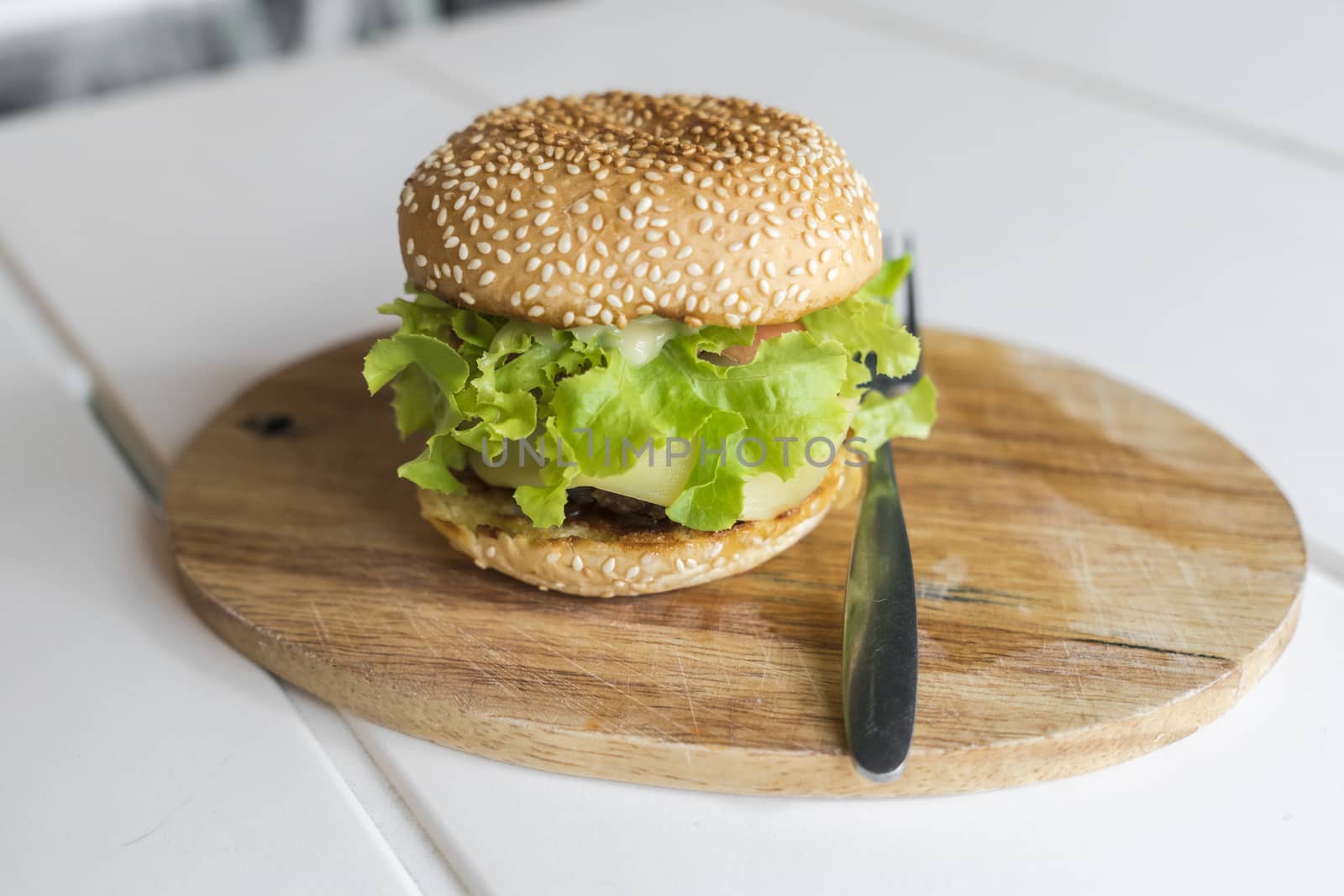 Hamburger on the wooden plate. Fast food concept by Buttus_casso