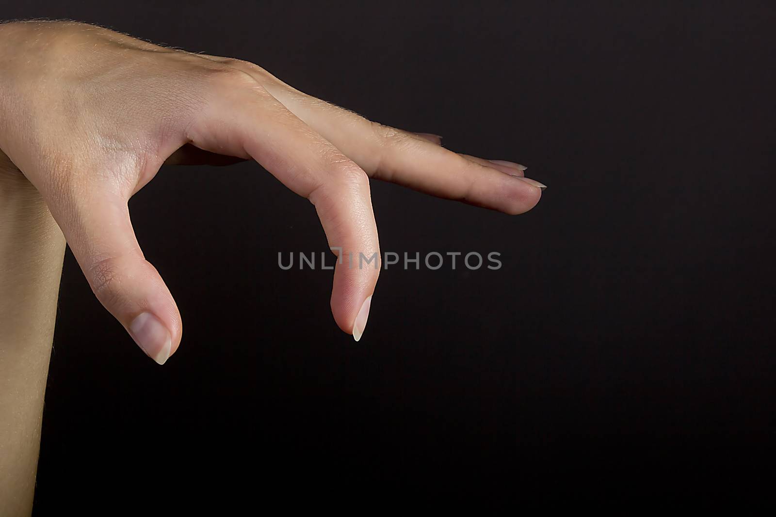 Female hand grab some item on black isolated background
