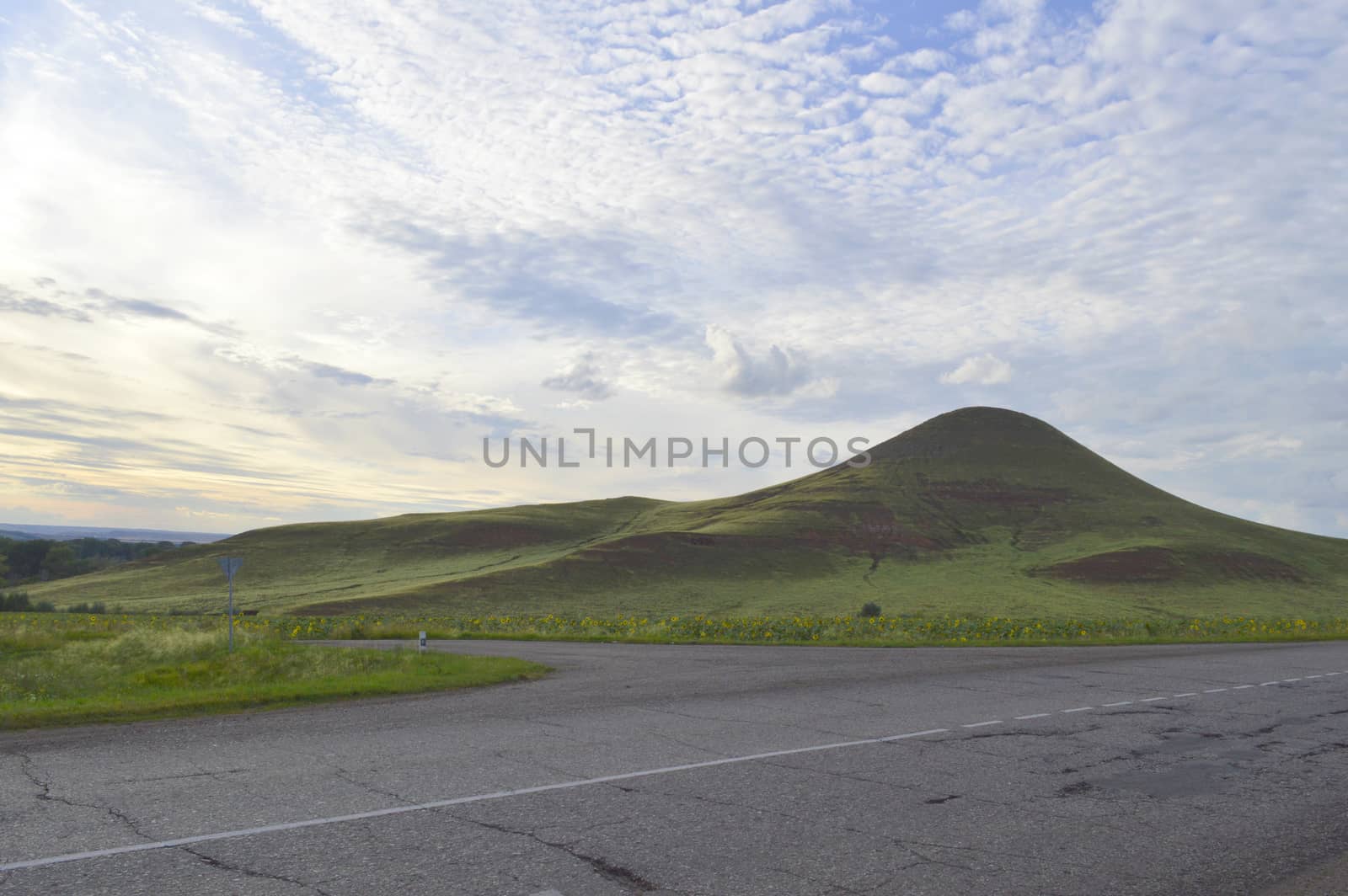 summer landscape with road, mountain and blue sky with clouds